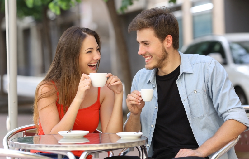 Couple or friends talking and drinking in a restaurant